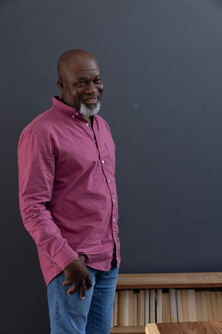 Confident Senior Man in Casual Clothing Standing Indoors