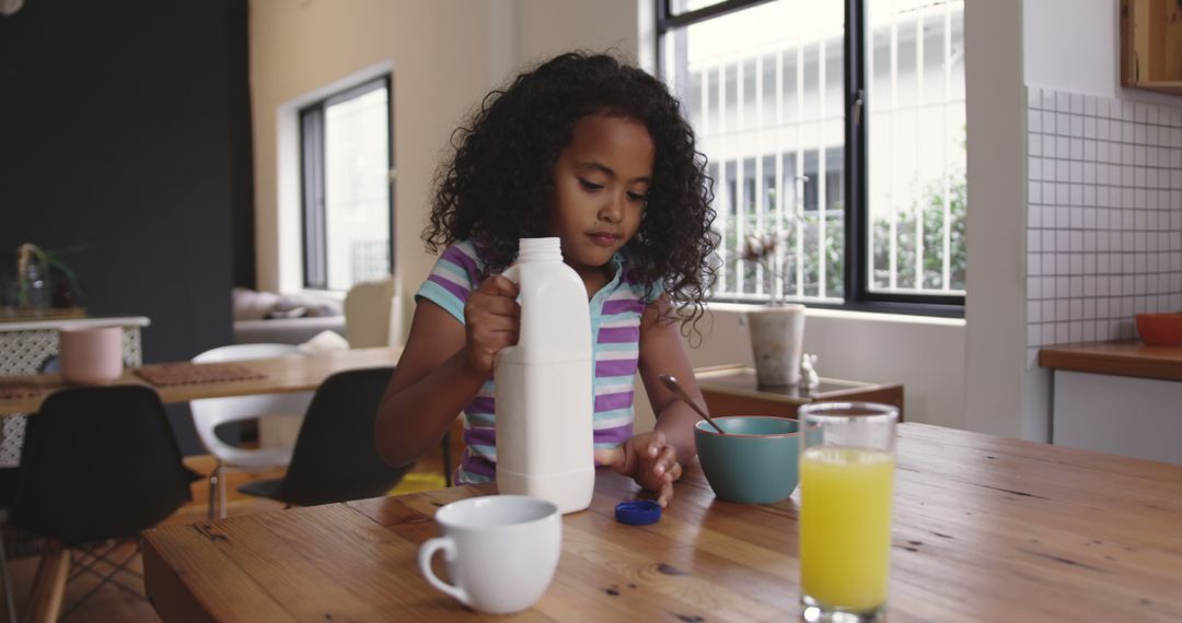 Young Girl Pouring Milk into Bowl for Breakfast at Home - Free Images, Stock Photos and Pictures on Pikwizard.com