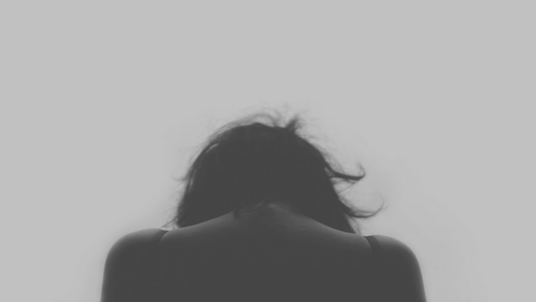 Silhouette of Woman Bowing Head in Grief - Free Images, Stock Photos and Pictures on Pikwizard.com