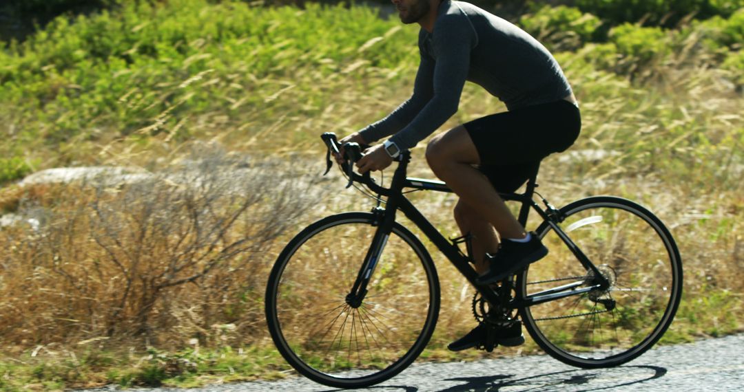 Cyclist riding bike on sunny day outdoors - Free Images, Stock Photos and Pictures on Pikwizard.com