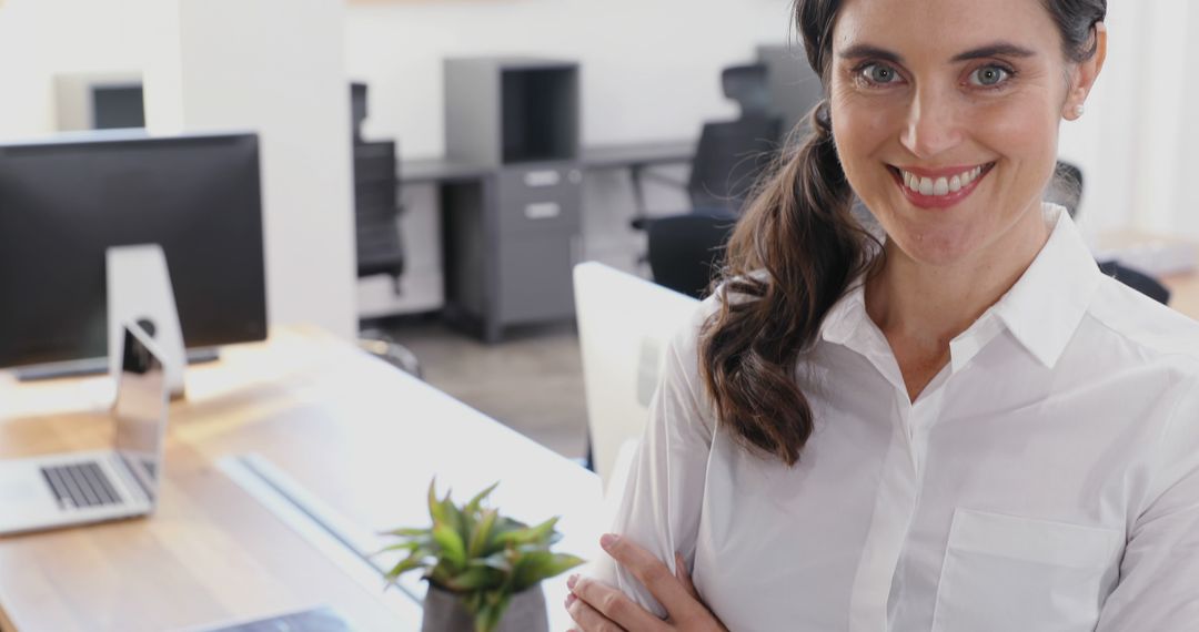 Smiling Professional Woman Standing in Modern Office Workspace - Free Images, Stock Photos and Pictures on Pikwizard.com