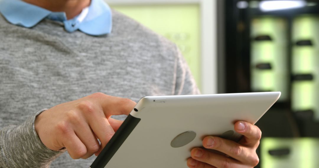 Midsection of Male Optometrist Using Tablet in Optical Office