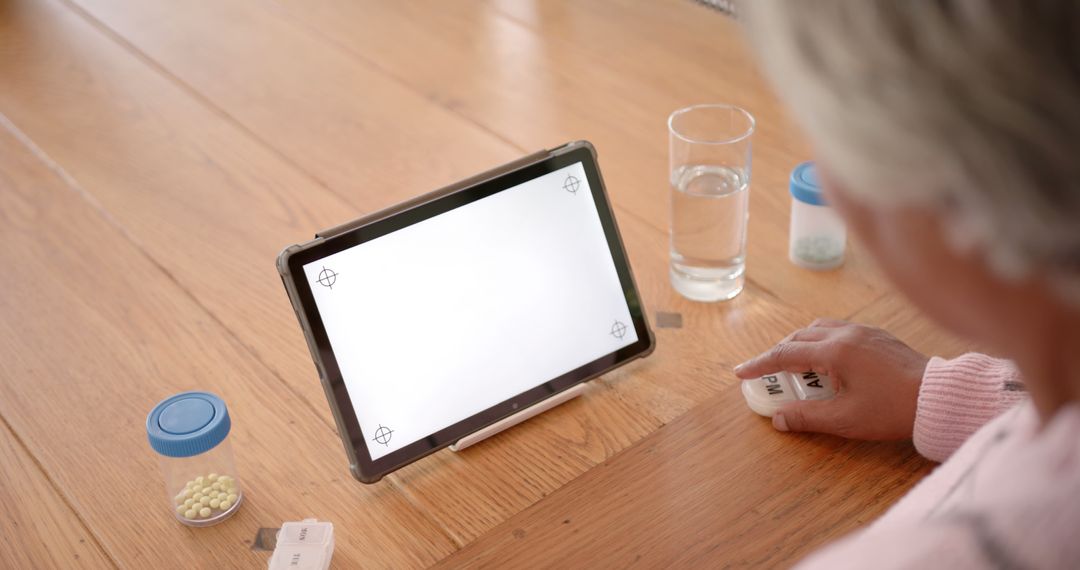 Senior Taking Medication While Using Digital Tablet - Free Images, Stock Photos and Pictures on Pikwizard.com