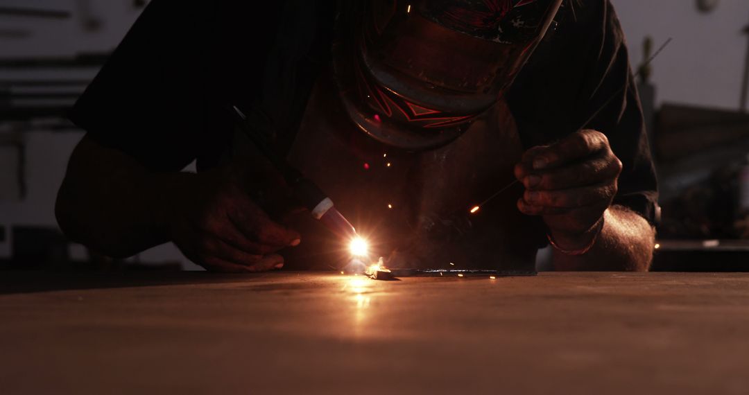 Welder Using Welding Torch in Dimly Lit Workshop - Free Images, Stock Photos and Pictures on Pikwizard.com