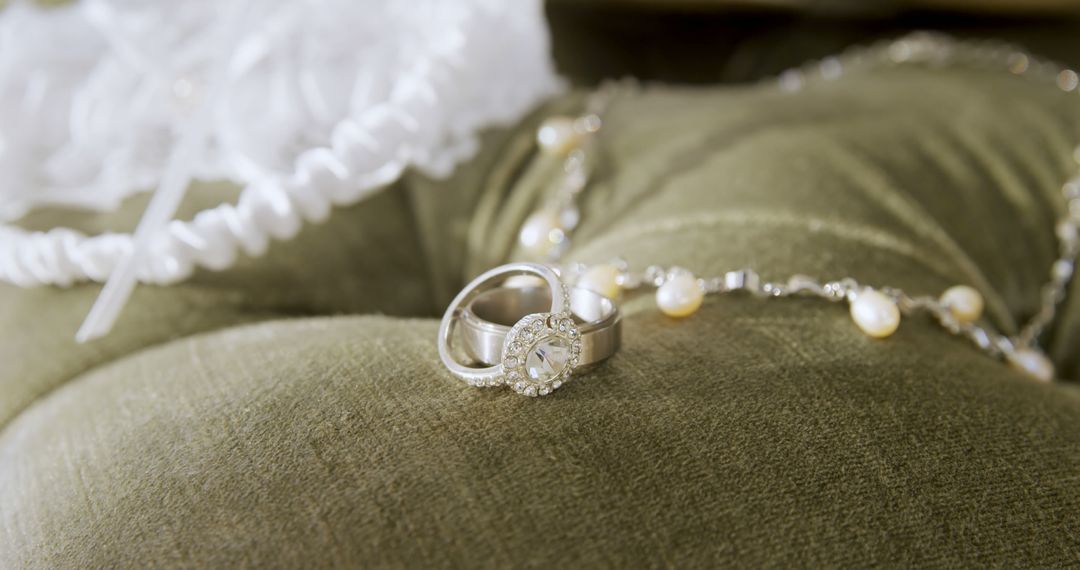 Close up of wedding rings and white transparent cloth on pillow - Free Images, Stock Photos and Pictures on Pikwizard.com
