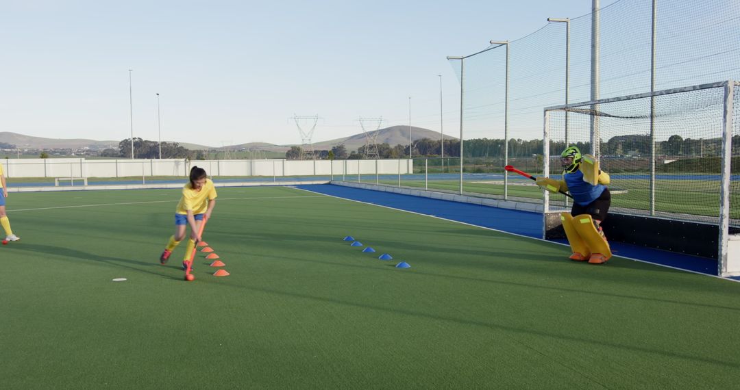 Girls Practicing Field Hockey Skills on Turf