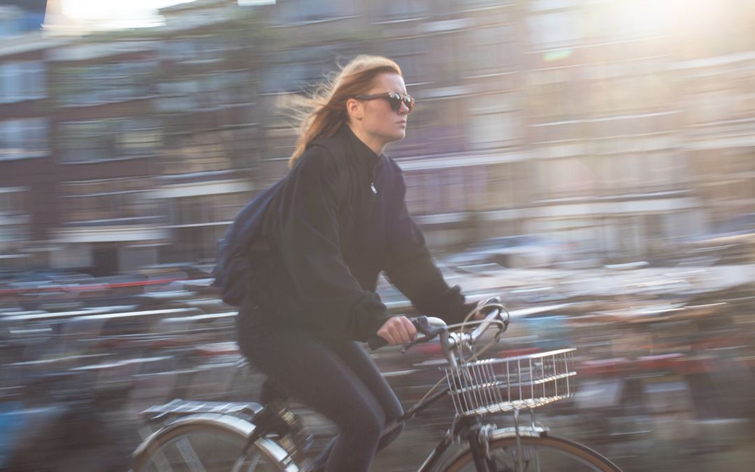 Woman Riding Bicycle in City with Motion Blur - Free Images, Stock Photos and Pictures on Pikwizard.com