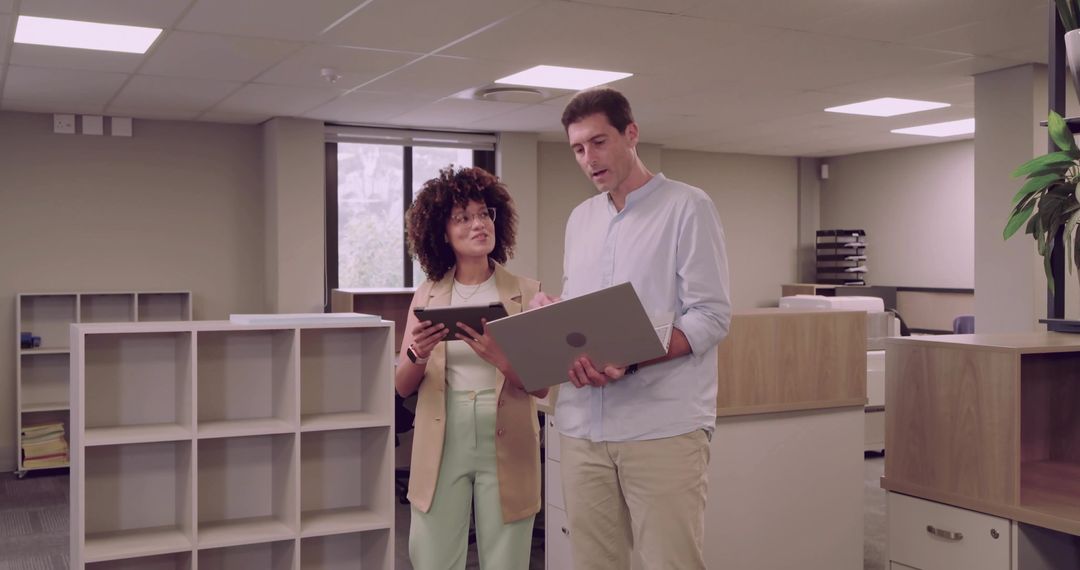 Colleagues Analyzing Sales Data in Modern Office Environment