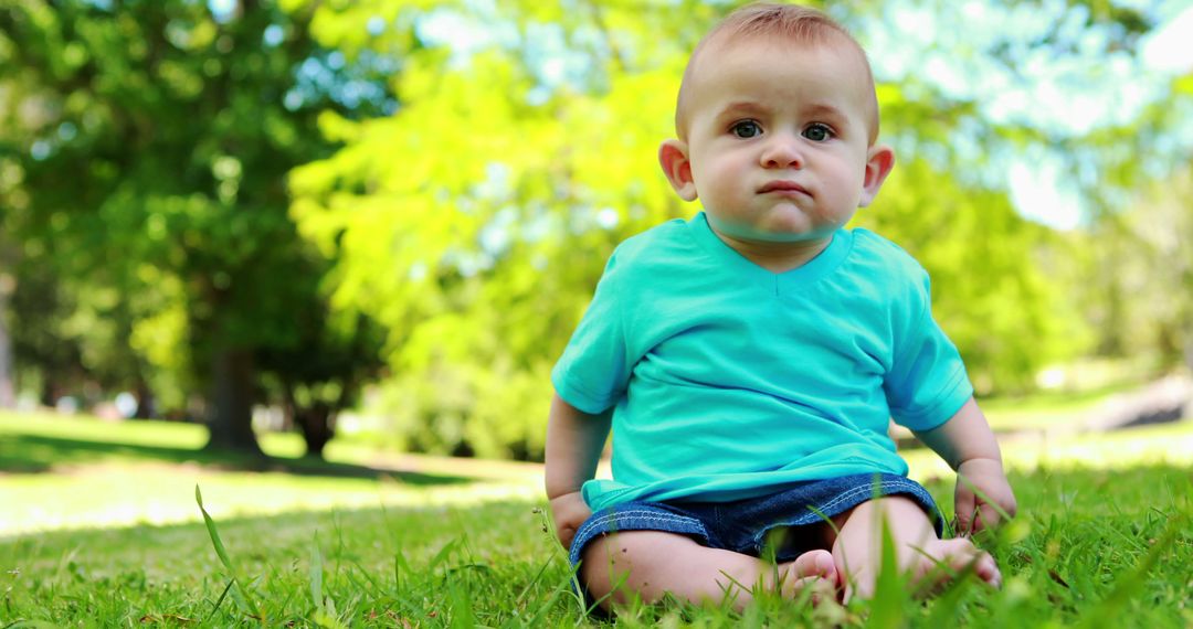 Cute Baby Sitting on Grass in Park on Sunny Day - Free Images, Stock Photos and Pictures on Pikwizard.com