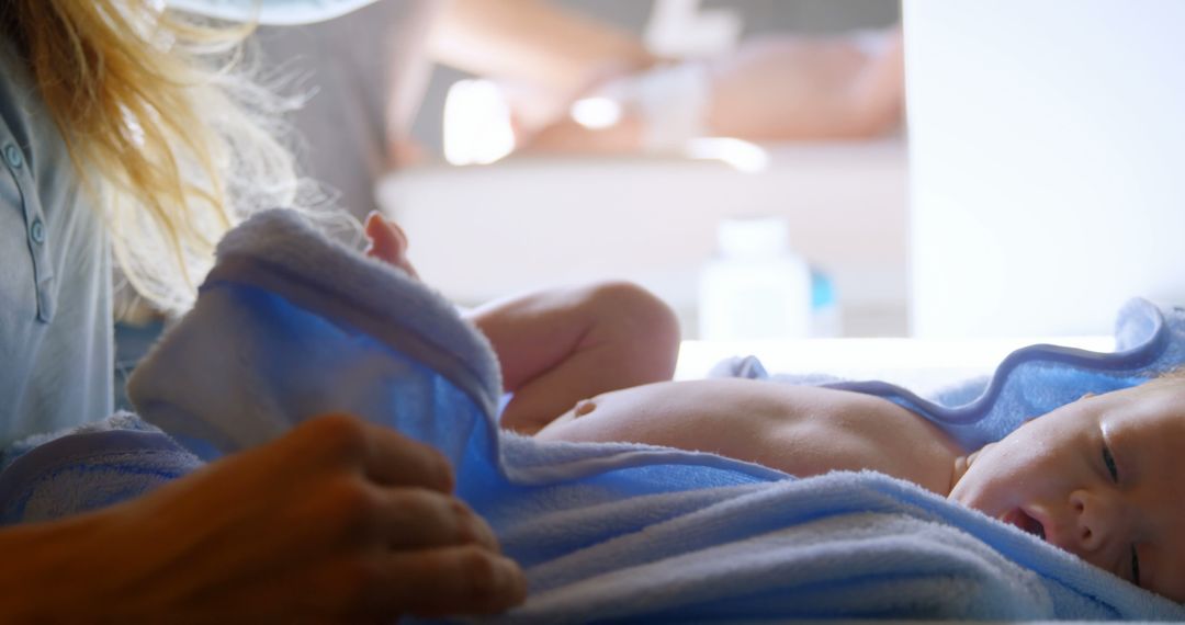 Baby Wrapped in Blue Blanket Being Tenderly Cared For - Free Images, Stock Photos and Pictures on Pikwizard.com