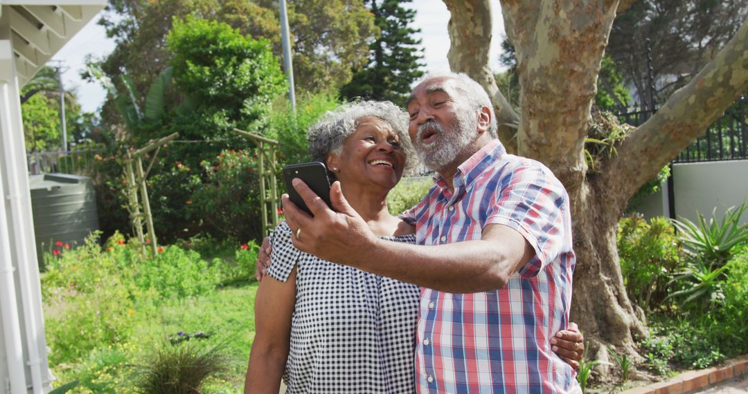 Happy Senior Couple Taking Selfie in Garden on Sunny Day - Free Images, Stock Photos and Pictures on Pikwizard.com