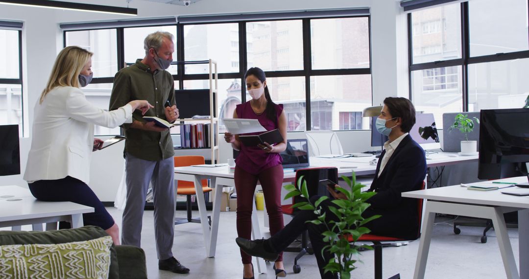 Business Team Collaborating in Office With Face Masks