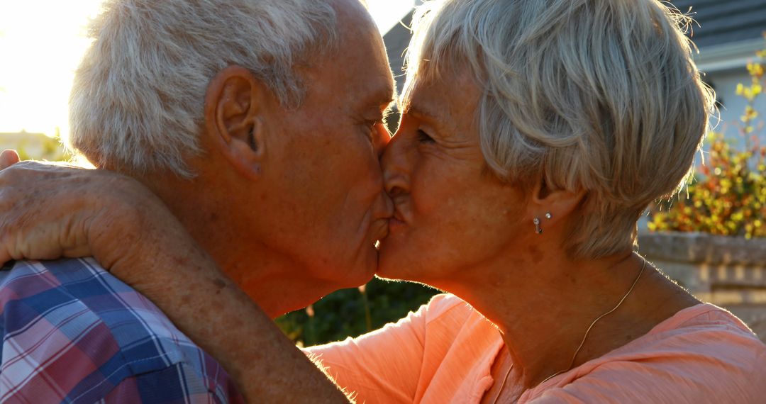 Elderly Couple Sharing Tender Kiss at Sunset - Free Images, Stock Photos and Pictures on Pikwizard.com