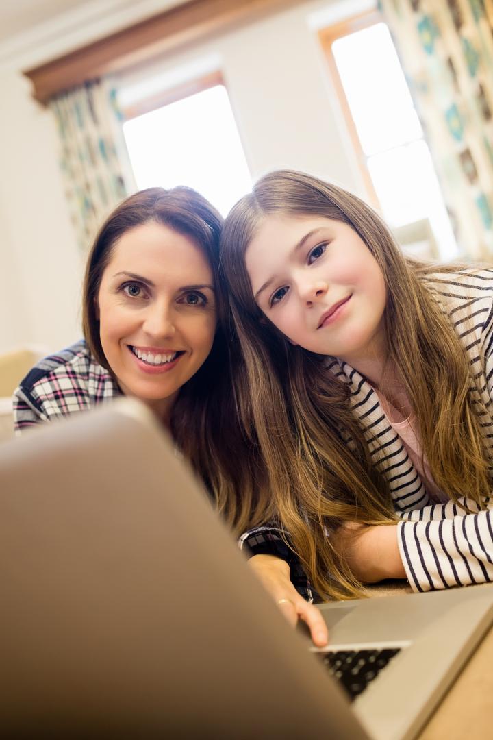 Mother and Daughter Smiling While Using Laptop at Home - Free Images, Stock Photos and Pictures on Pikwizard.com