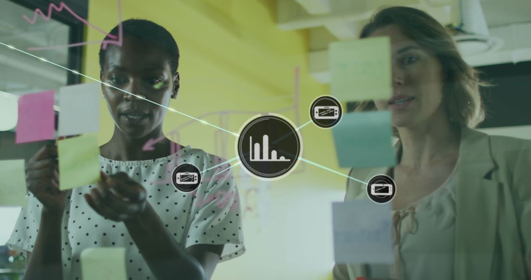 Diverse Female Colleagues Planning Strategy with Digital Interface