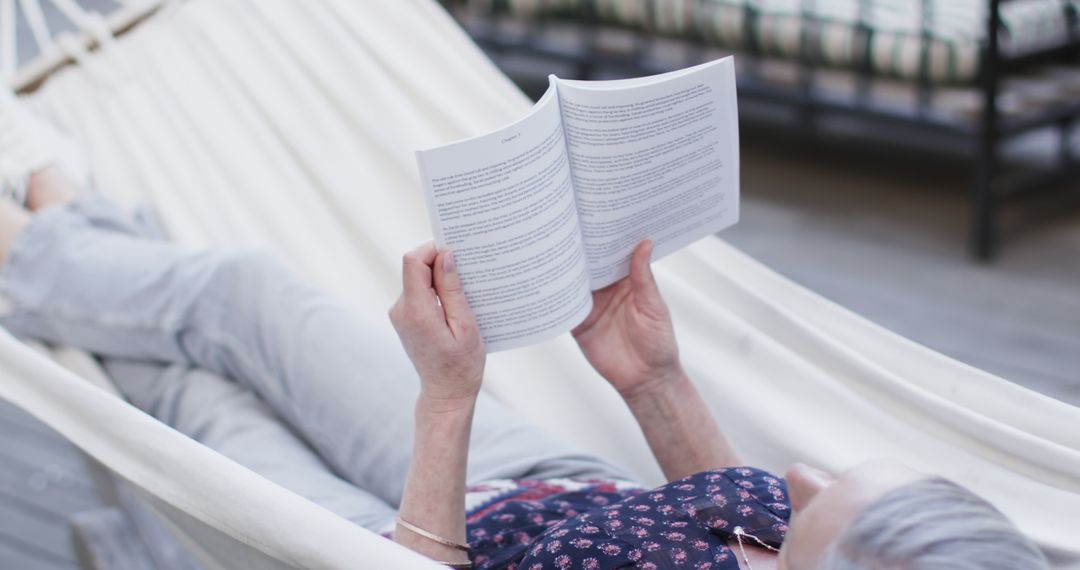 Senior Woman Relaxing in Hammock Reading Book Outdoors - Free Images, Stock Photos and Pictures on Pikwizard.com