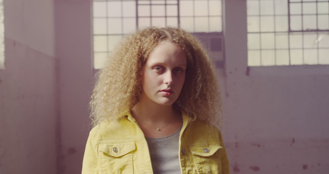 Confident Woman with Curly Hair in Yellow Jacket - Free Images, Stock Photos and Pictures on Pikwizard.com