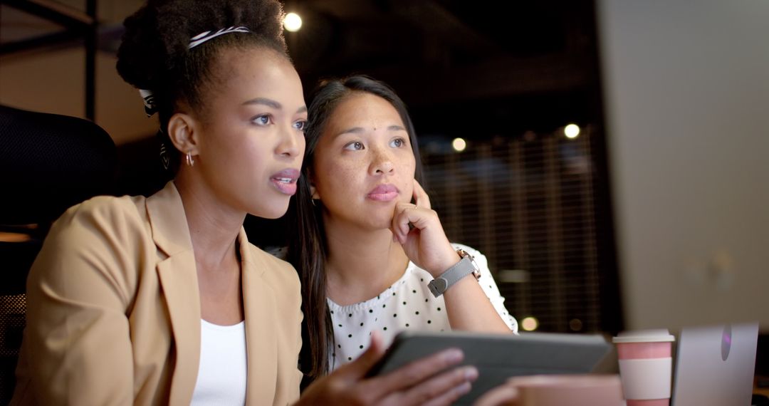 Two Businesswomen Collaborating in a Modern Office Environment