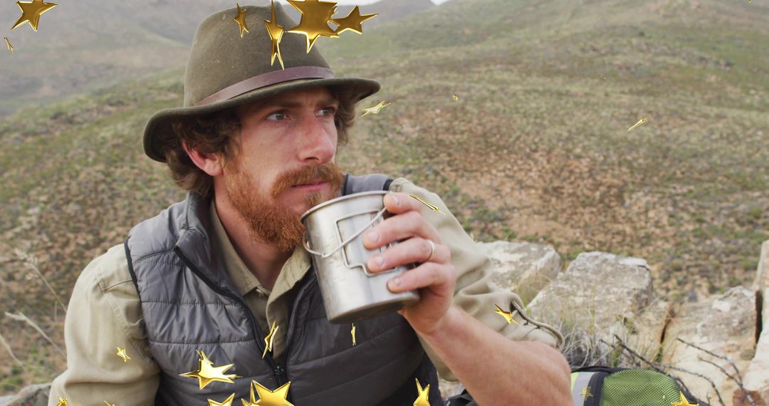 Bearded Adventurer Sipping Coffee in Rugged Hillside