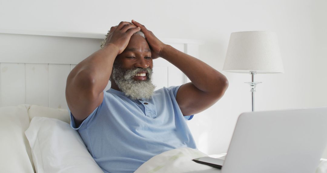 Senior African American Man Frustrated with Laptop in Bedroom - Free Images, Stock Photos and Pictures on Pikwizard.com