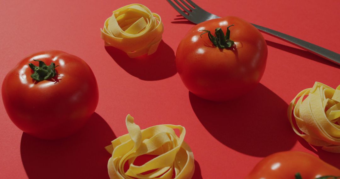 Fresh Tomatoes and Pasta Noodles on Red Background - Free Images, Stock Photos and Pictures on Pikwizard.com