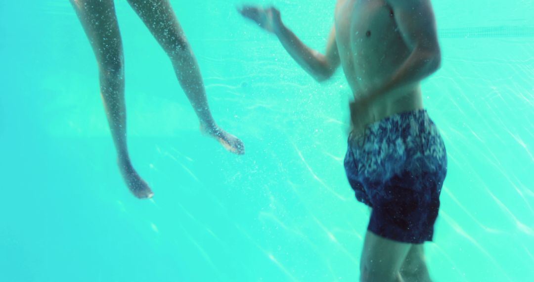 Underwater View of Couple in Swimming Pool