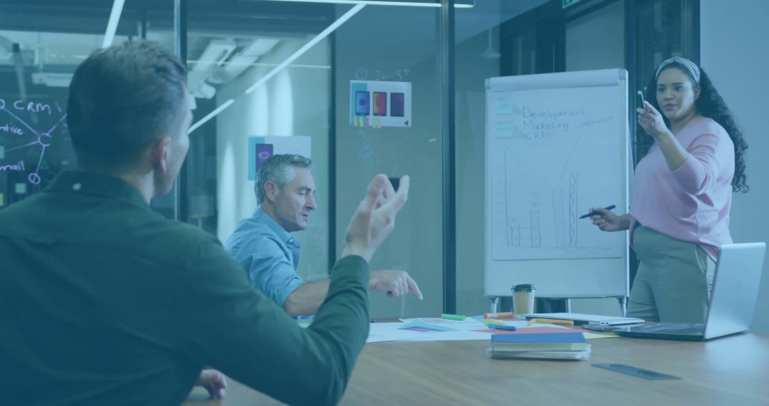 Business Team Discussing Strategy with Flipchart in Modern Office