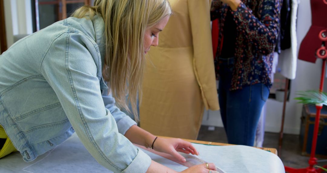 Female Fashion Designer Working in Studio Cutting Fabric - Free Images, Stock Photos and Pictures on Pikwizard.com