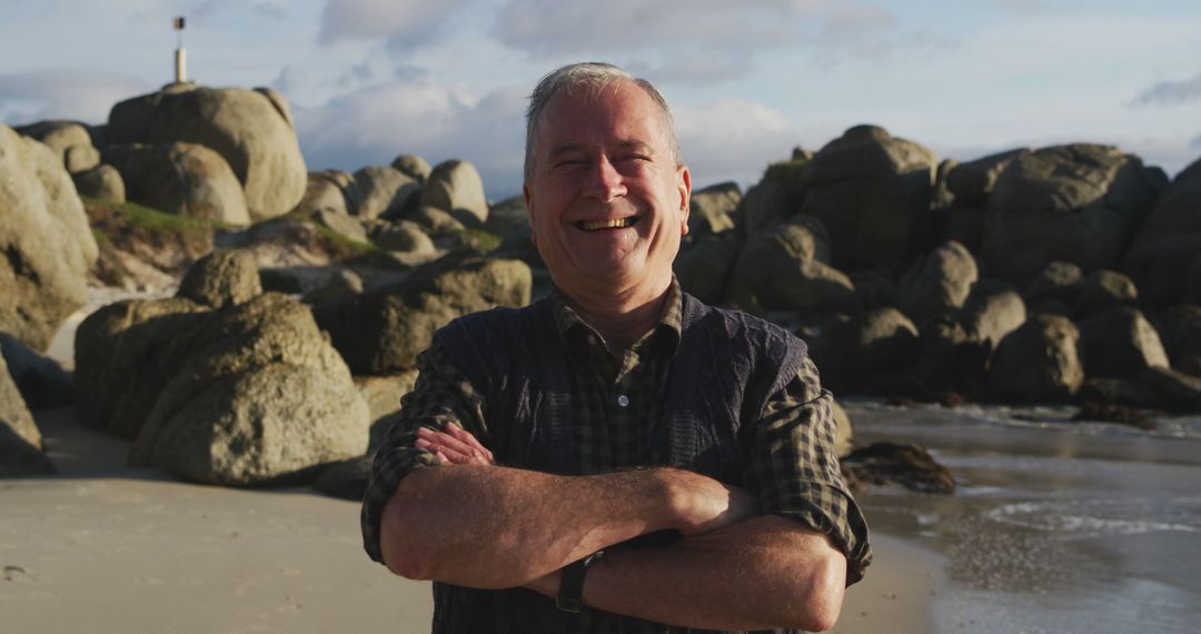 Senior Man Smiling on Rocky Beach Under Blue Sky - Free Images, Stock Photos and Pictures on Pikwizard.com