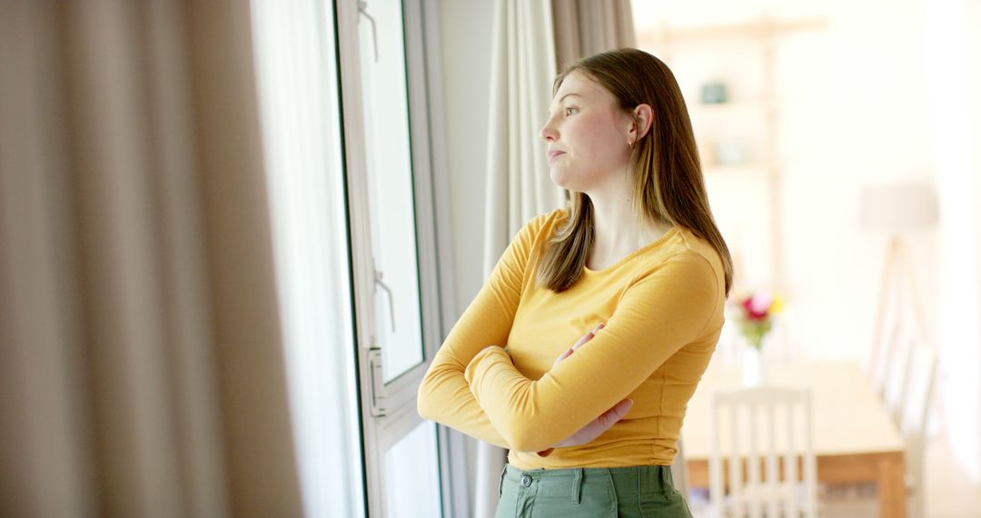 Thoughtful Young Woman Daydreaming by Window at Home - Free Images, Stock Photos and Pictures on Pikwizard.com