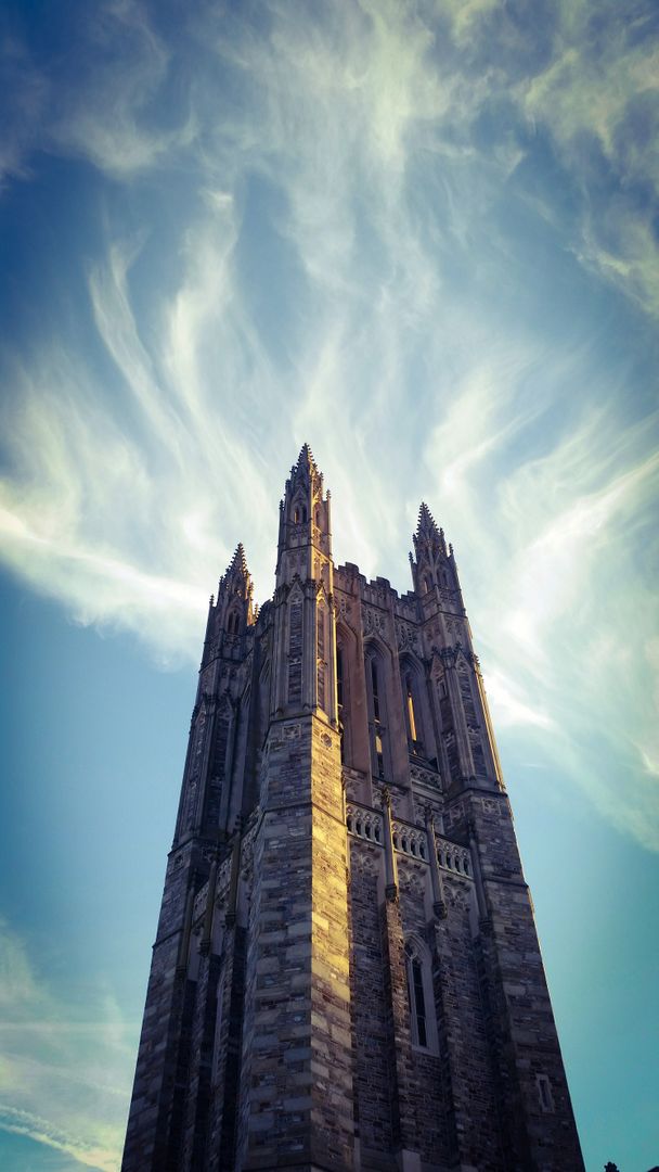 Gothic-style Church Tower against Dramatic Sky - Free Images, Stock Photos and Pictures on Pikwizard.com