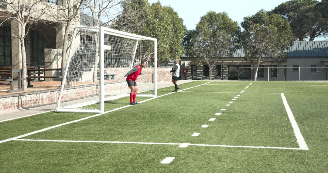 Soccer Player Scores Dramatic Goal while Goalkeeper Reacts