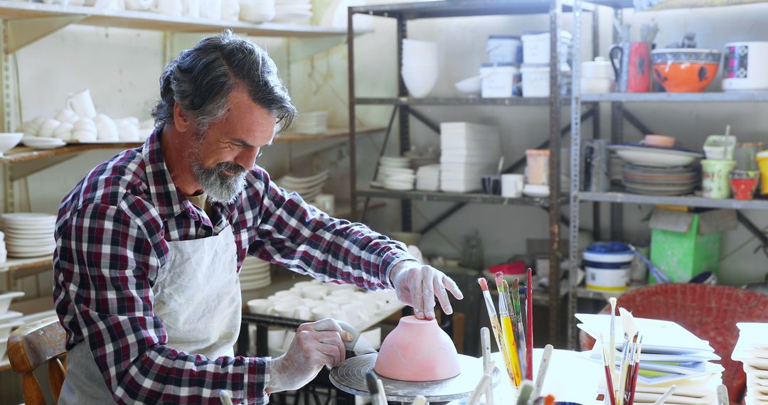 Mature Man in Apron Working on Pottery in Studio - Free Images, Stock Photos and Pictures on Pikwizard.com