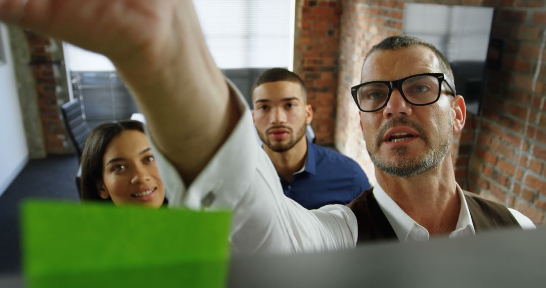 Diverse Team Collaborating Using Sticky Notes in Office