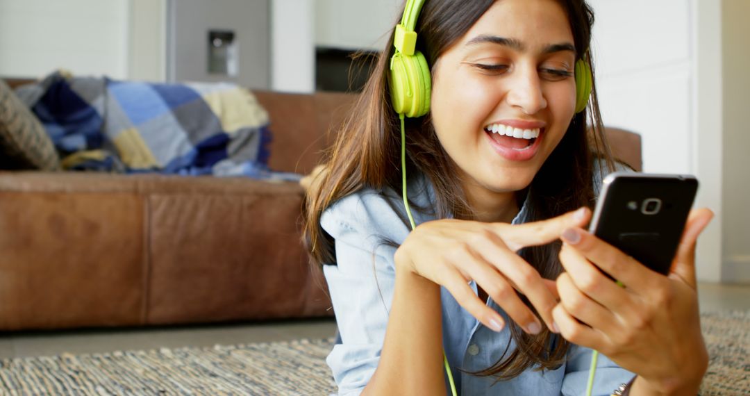 Smiling Young Woman Enjoying Music with Green Headphones - Free Images, Stock Photos and Pictures on Pikwizard.com