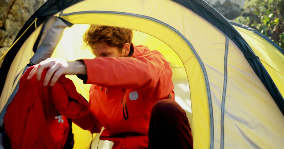 Man Enjoying Wilderness Adventure Inside Tent