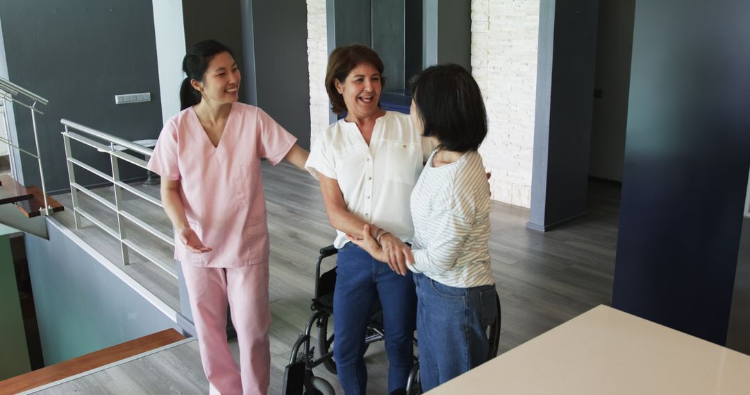 Senior Woman in Wheelchair with Nurse and Friend in Friendly Discussion