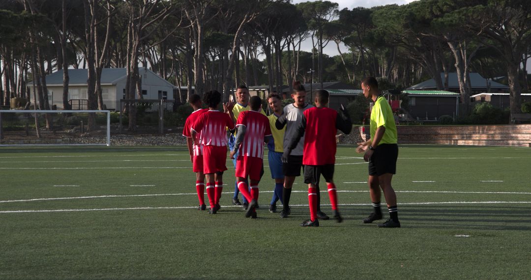 Soccer Players Celebrating Victory on Field Displaying Camaraderie