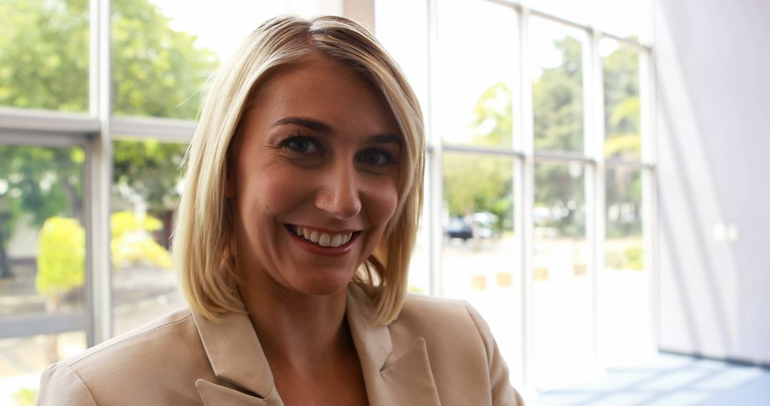 A smiling young Caucasian businesswoman is pictured indoors, with copy space - Free Images, Stock Photos and Pictures on Pikwizard.com