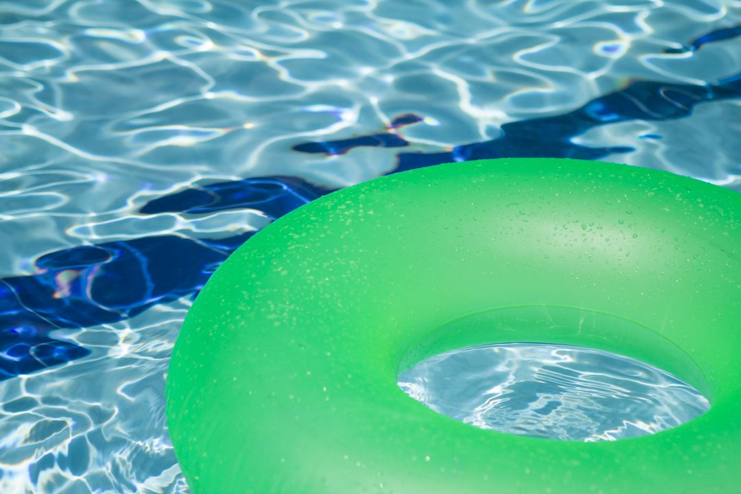 Green Inflatable Ring Floating on Clear Pool Water - Free Images, Stock Photos and Pictures on Pikwizard.com