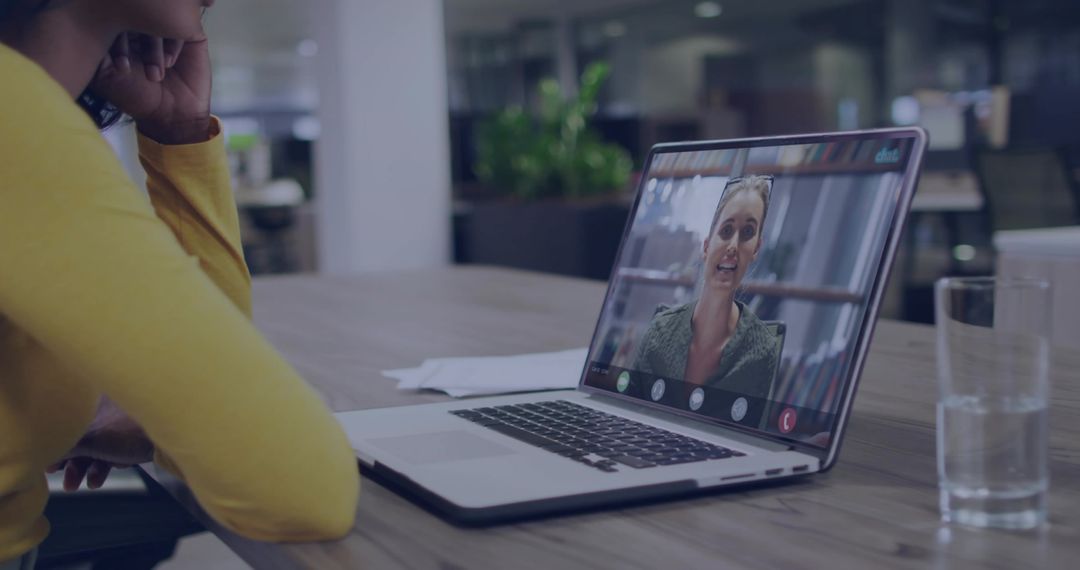 Woman Engaging in Online Meeting with Colleague in Office