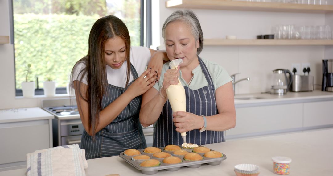 Elderly Woman and Young Girl Decorating Cupcakes in Modern Kitchen
