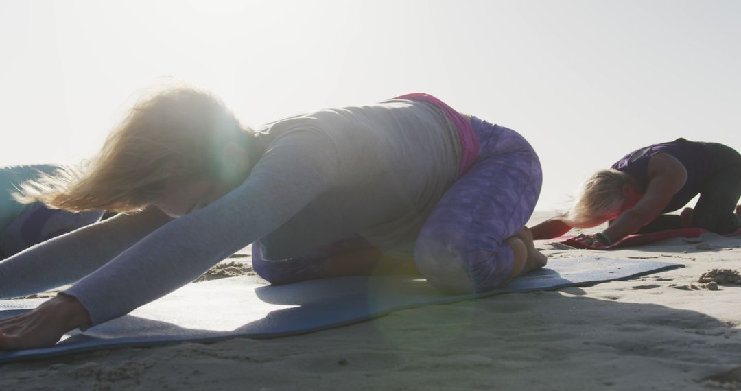 Women Practicing Yoga on Beach During Sunrise - Free Images, Stock Photos and Pictures on Pikwizard.com