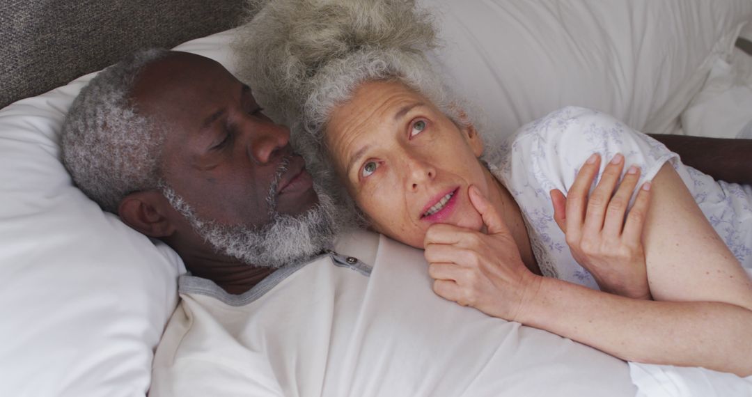 Senior Couple Relaxing in Bed Embracing Each Other - Free Images, Stock Photos and Pictures on Pikwizard.com