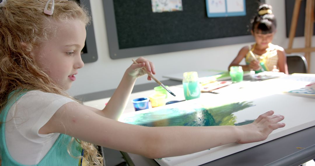Creative Expression as Children Paint on Canvas in Classroom