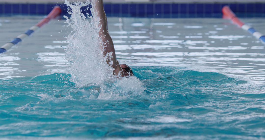 Competitive Swimmer Backstroking in Indoor Pool