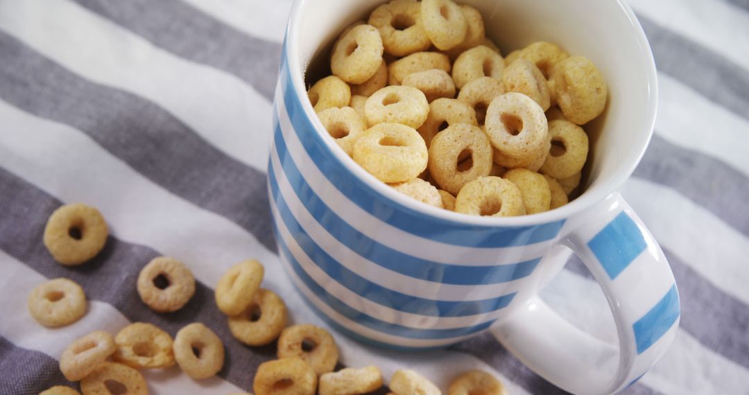 Mug Filled with Breakfast Cereal on Striped Cloth - Free Images, Stock Photos and Pictures on Pikwizard.com