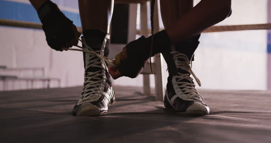 Boxer Tying Laces on Boxing Shoes in Gym - Free Images, Stock Photos and Pictures on Pikwizard.com