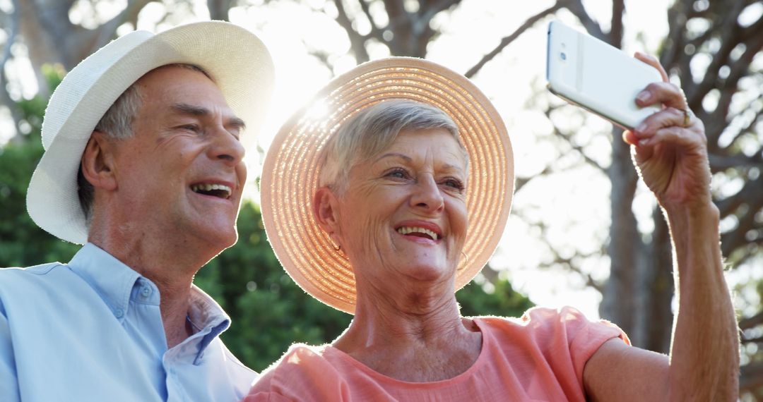 Happy Senior Couple Taking Selfie Outdoors in Sunlight - Free Images, Stock Photos and Pictures on Pikwizard.com