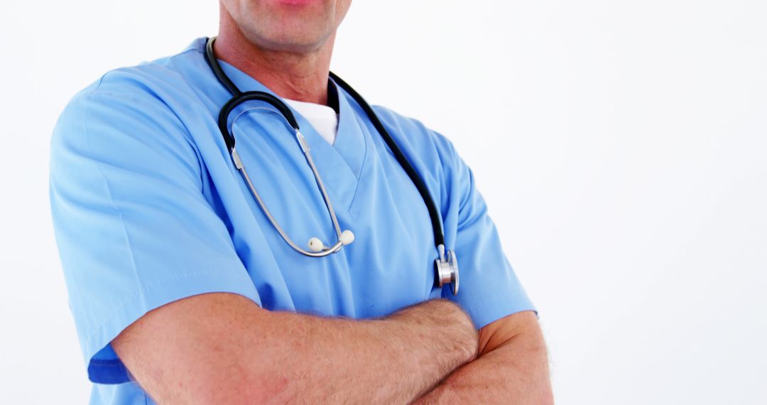 Confident Male Doctor Wearing Blue Scrubs and Stethoscope - Free Images, Stock Photos and Pictures on Pikwizard.com